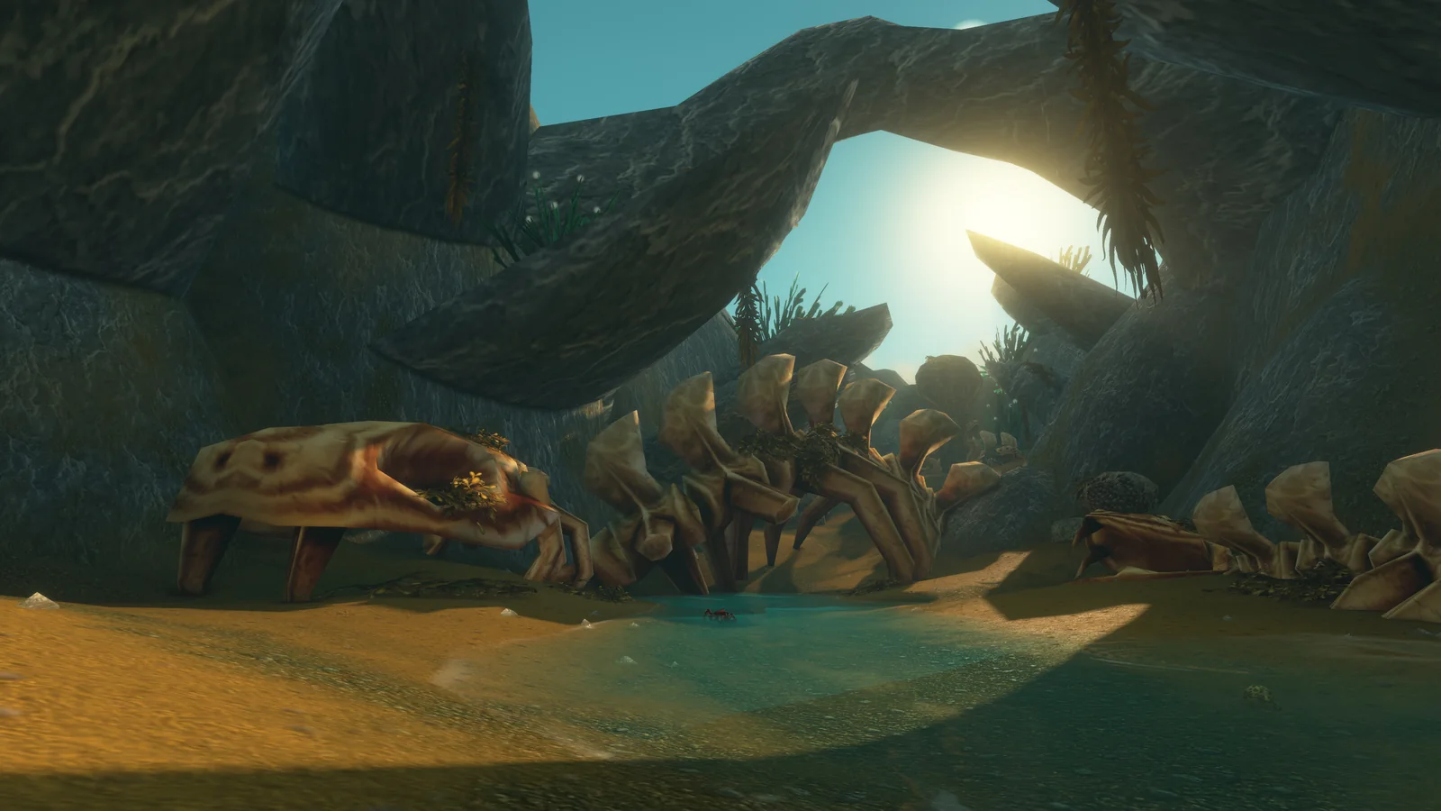 Un squelette géant sous une arche de pierre. Rhysdog passe devant juste avant le portail. Image : Blizzard.